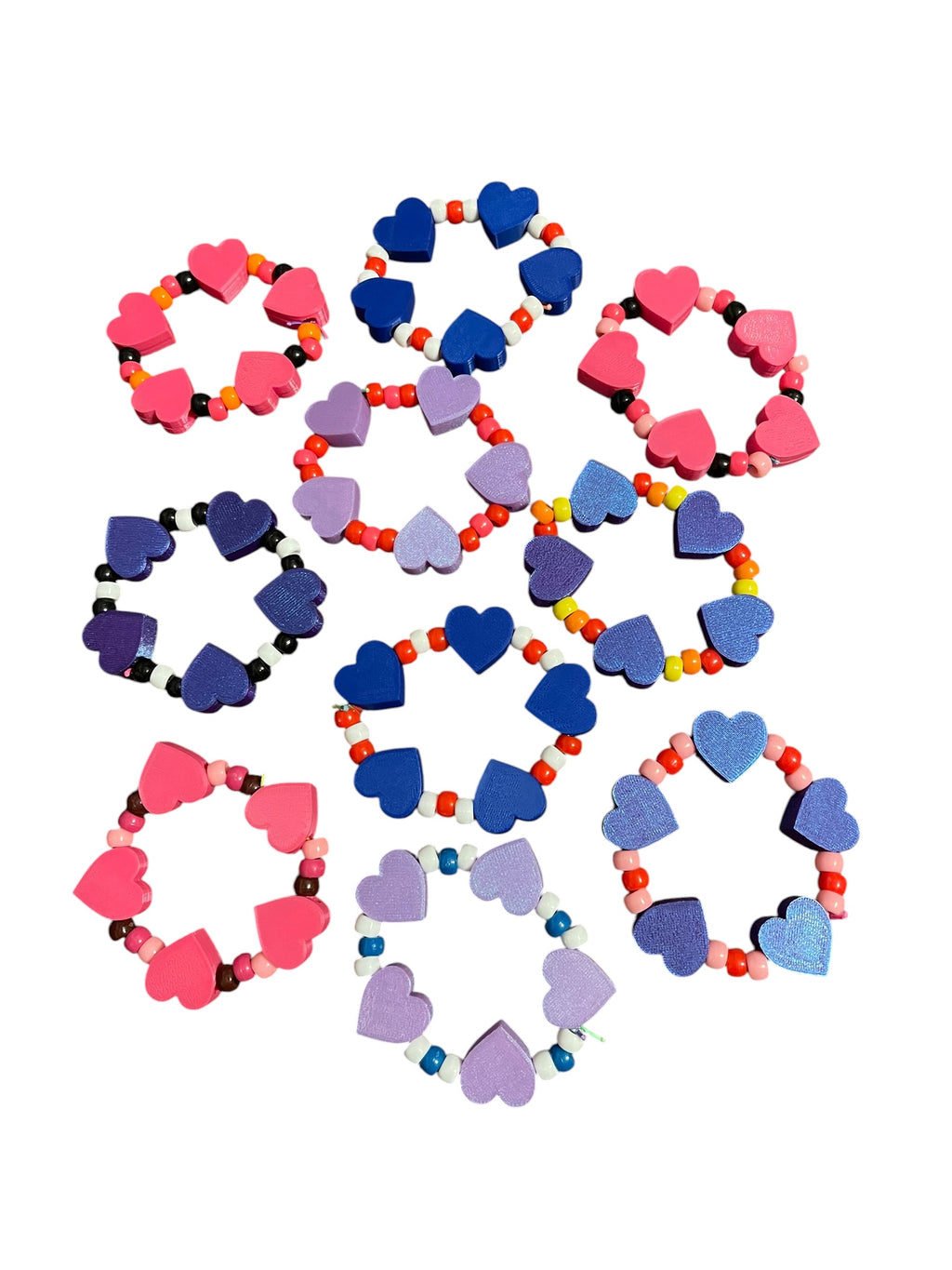 A set of heart-shaped 3d printed bead bracelets in various colors including pink, blue and purple, arranged on a plain white background.