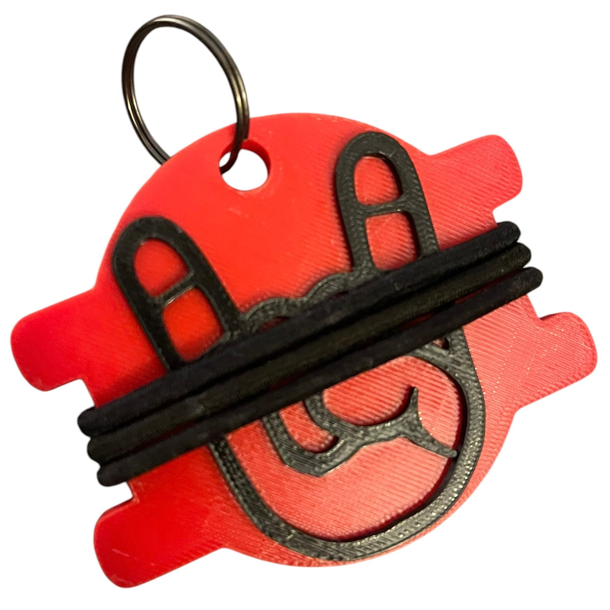 A red 3D-printed keychain with black elastic bands across the rock on hand, attached to a metal split ring, shown on a plain white background.