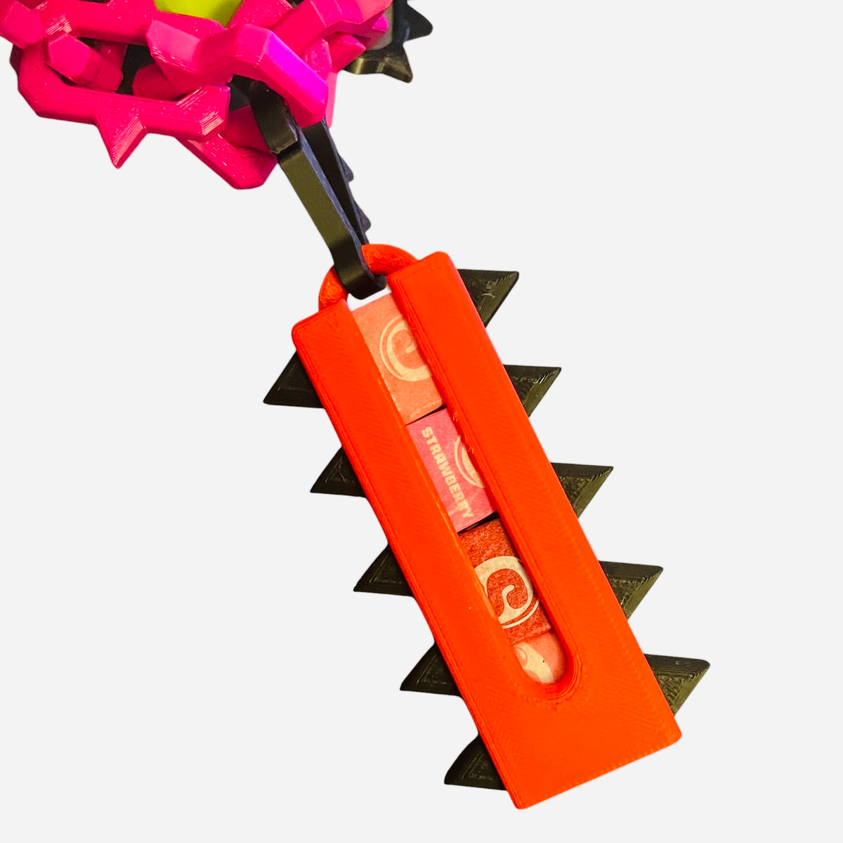 A red keychain holder full of candy.