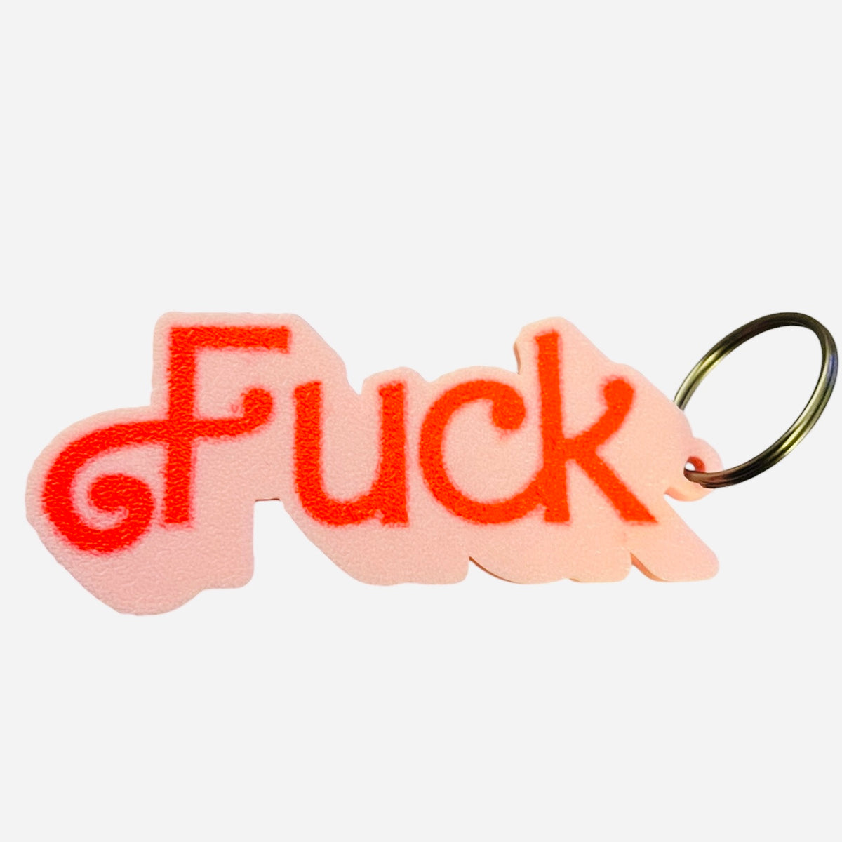 A novelty keychain featuring the word 'Fuck' in red lettering on a light pink 3d printed background, attached to a black metal split ring, shown against a plain white background.