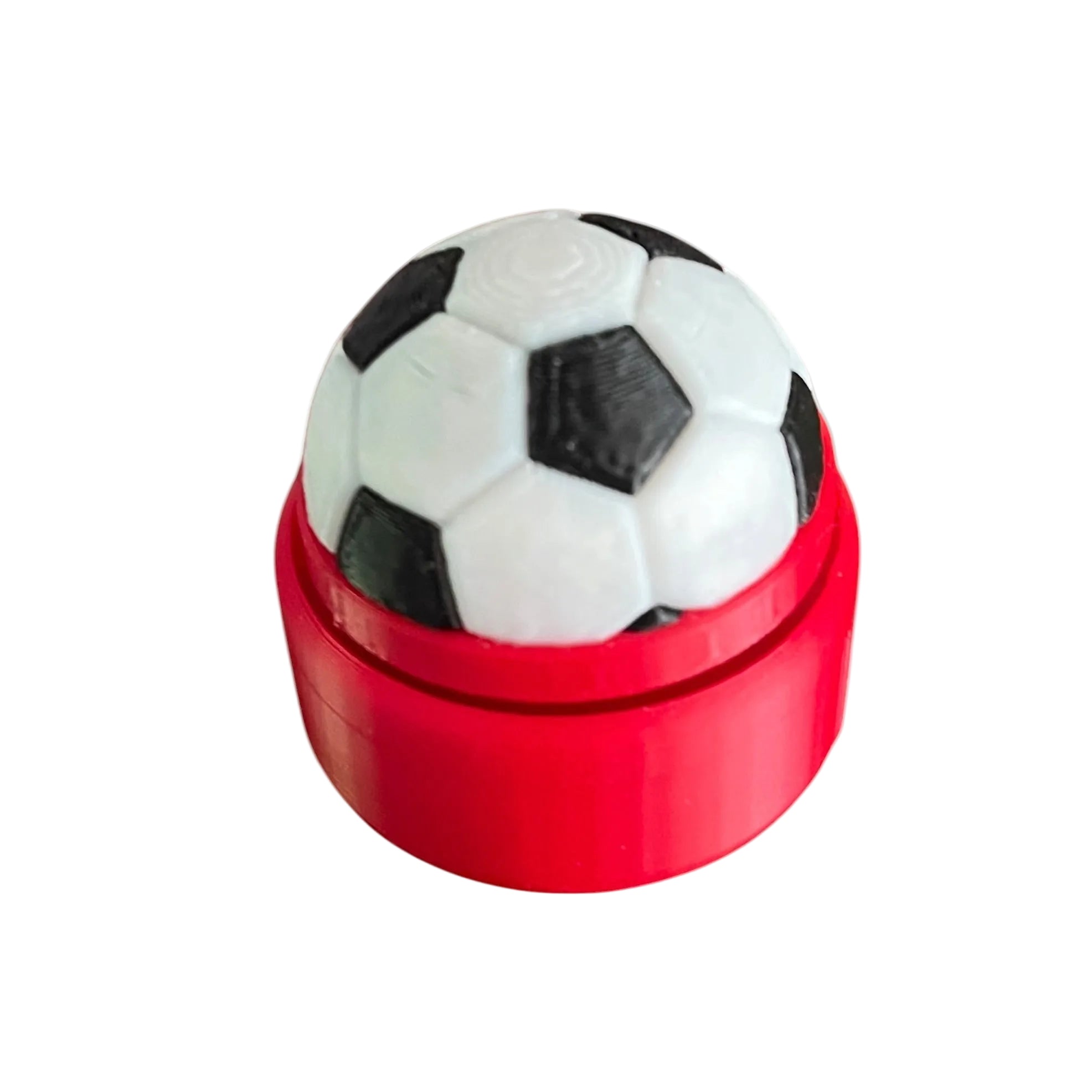 Soccer ball-shaped clicker in a red base on a white background