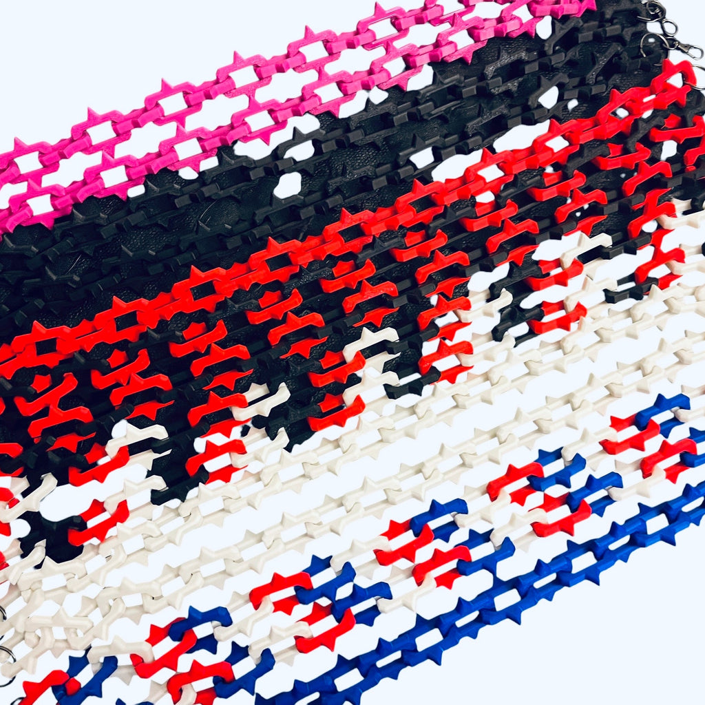 Several plastic chain-link style accessories arranged in vertical rows on a white background, shown in blue, white, red, black, and pink.