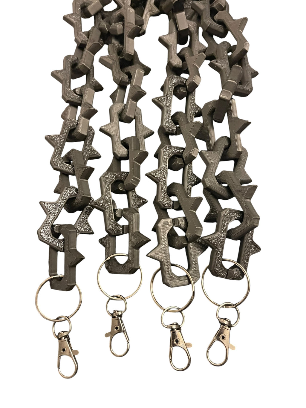 Matte black plastic keychain lanyards with interlocking studded links and gun metal color lobster clasp rings, shown on a plain white background.