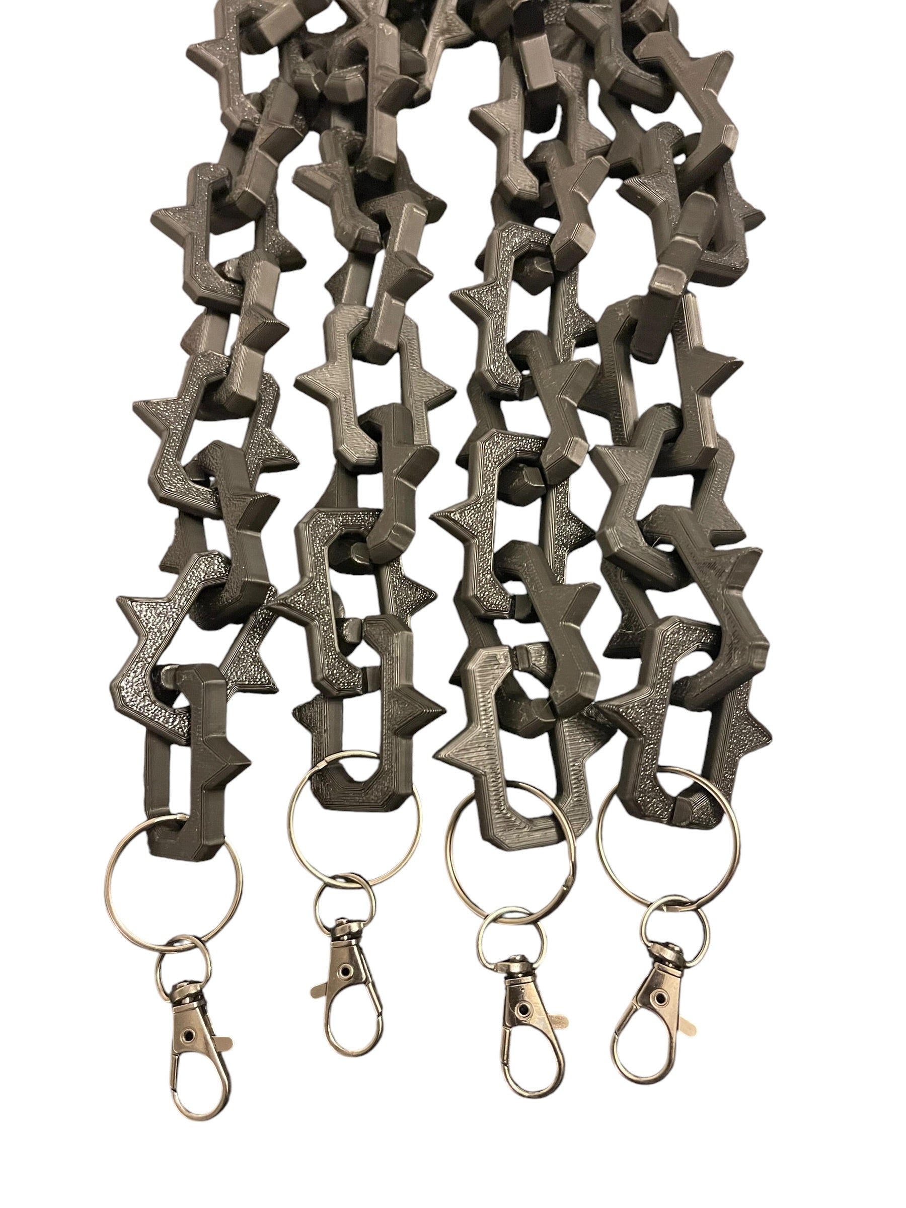 Matte black plastic keychain lanyards with interlocking studded links and gun metal color lobster clasp rings, shown on a plain white background.