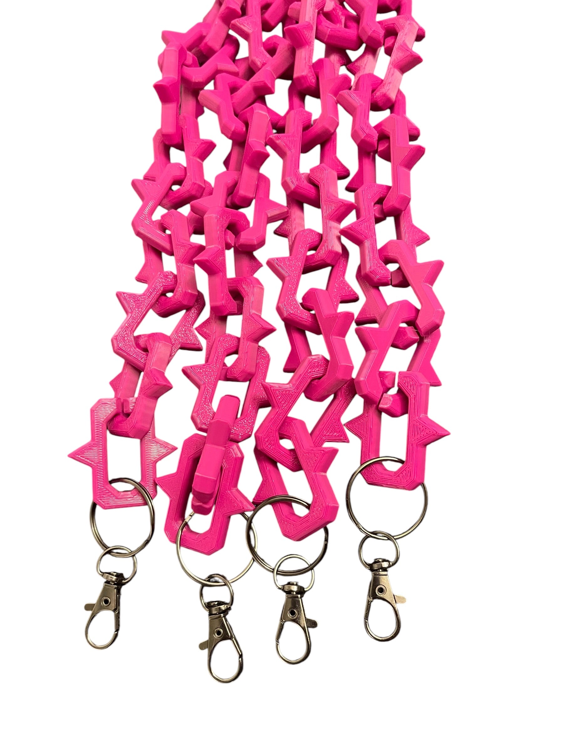 Bright pink plastic keychain lanyards with interlocking studded links and gun metal color lobster clasp rings, shown on a plain white background.