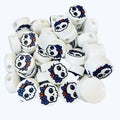 White round beads with a girly skull design with red hair and a blue bow. 