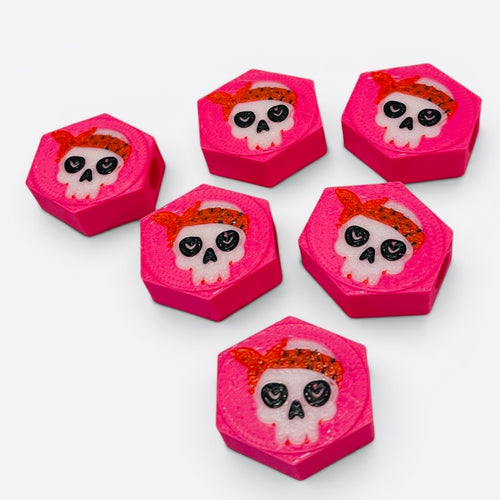 Pink hexagonal beads with girly skull design with red bandanas.